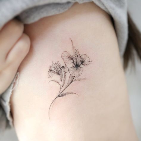 Violet And Iris Tattoo, Iris Flowers Tattoo, Violet Flower Tattoos, Iris Flower Tattoo, Flower Tattoo On Ribs, Tattoos On Side Ribs, Shoulder Cap Tattoo, Iris Tattoo, Small Flower Tattoos