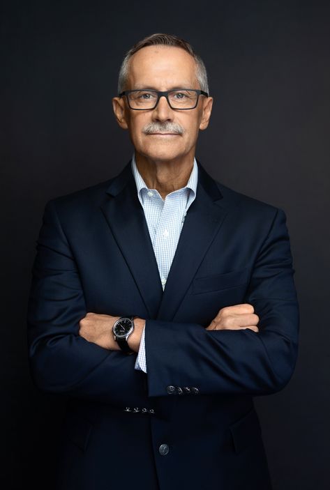 Business headshot of mature man wearing glasses with arms crossed smiling. Headshots For Pastor, Ceo Headshots Business Portrait Men, Standing Headshot Poses Men, Ceo Portraits Men, Studio Corporate Portrait, Corporate Photography Men, Husband Wife Business Photoshoot, Real Estate Portraits Men, Linked In Headshots