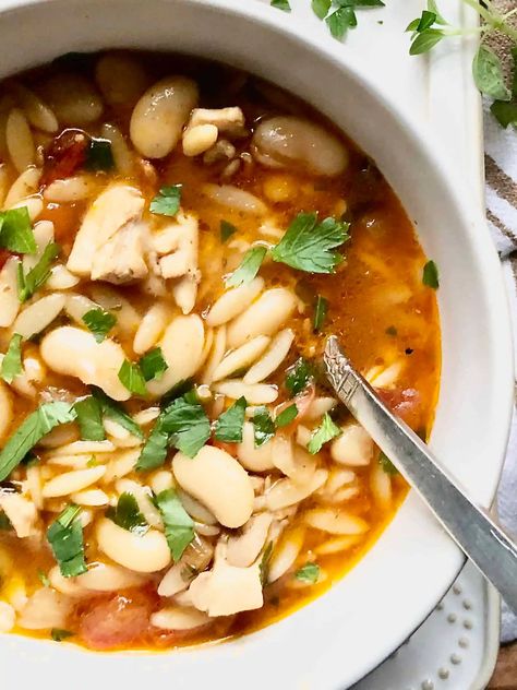 This Tuscan Chicken & White Bean Soup is a soup that eats like a stew. Full of flavor, beans and pasta. Just add some crusty bread and a salad of bitter greens. Perfect meal for a chilly evening. A Hint of Rosemary #soups #stews #hearty #beans #pasta #dinner #lunch #crowdpleaser #glutenfree #bacon #chicken #ahintofrosemary Tuscan Chicken White Bean Soup, Chicken White Bean Soup, Butter Bean Soup, Bacon Chicken, Bitter Greens, Tuscan Chicken, Bean Stew, Boat Food, White Bean Soup