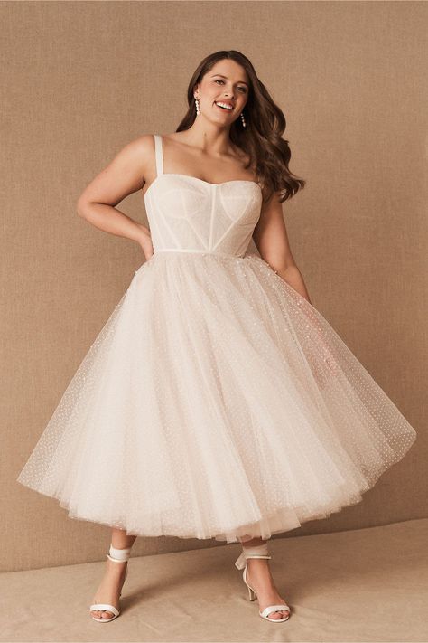 This vintage wedding dress with a tulle skirt is one of our WeddingWire editors' top picks. WeddingWire has tons of recommendations for wedding dresses and jumpsuits for all wedding types. Click for more courthouse wedding dress ideas. Planning your wedding has never been so easy (or fun!)! WeddingWire has tons of wedding ideas, advice, wedding themes, inspiration, wedding photos and more. {BHLDN} Floral Wedding Dress Simple, Short White Dress Plus Size, Plus Size Tea Length Wedding Dress, Plus Size Elopement Dress, Nutcracker Wedding, City Hall Wedding Dress, Pop Wedding, Plus Size Midi Dress, Wedding Activity