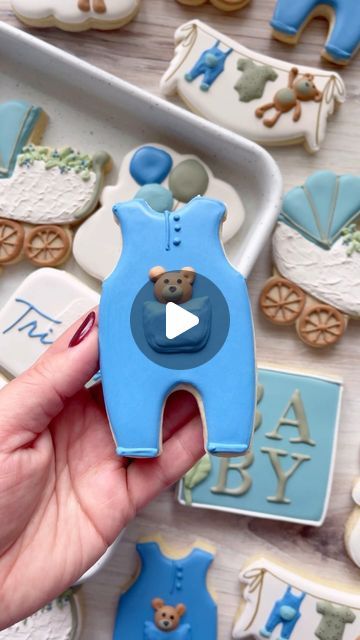 Amber Garcia on Instagram: "One of my most favorite things about creating a baby shower cookie set is making baby clothes. A onesie cookie is never not adorable 💙🐻 . . . . . . . . #cookiereels #cookievideo #cookievideos #cookiedecorating #cookiedecoratingvideo #cookiedecoratingvideos #bakingtutorial #cookieflood #satisfyingvideos #designercookies #cookier #sugarcookiedecorating #sugarcookies #instacookies #sugarcookiesofinstagram #decoratedsugarcookies #satisfying #cookietutorial #cookieart #relaxing #baker #desserttable #royalicingcookies #royalicingart #decoratedcookies #babyshowercookies #babyboy #teddybear #babyclothes #babycookies" Making Baby Clothes, Onesie Cookies, Cookie Videos, Baking Tutorial, Cookie Tutorials, Decorating Videos, Baby Cookies, Cookie Icing, Cookies Decorated