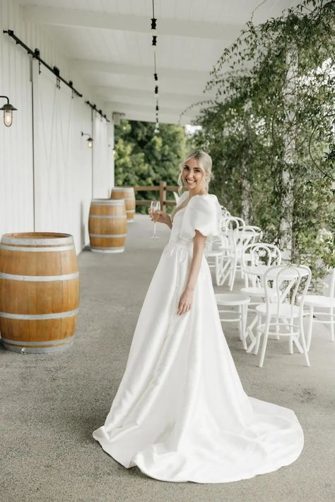 Chessy wears the Taryn & Camille wedding dress by Karen Willis Holmes, a U neck ballgown with a full skirt with pockets. Karen Willis Holmes Wedding Dress, Camille Wedding Dress, Bug Board, Wedding Gown With Sleeves, Australian Wedding Dress Designers, Australian Wedding Dresses, Wedding Dresses Australia, Buy Wedding Dress Online, Veil Dress