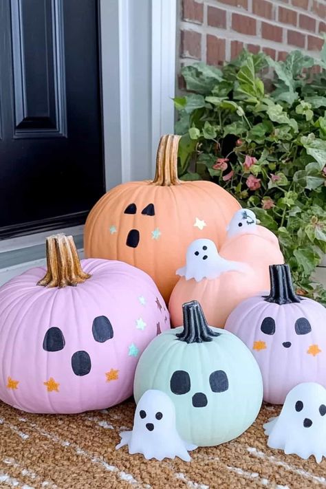 Four pastel pumpkins with ghost candels sitting on a doorstop. Pumpkin Painting Ideas Minimalist, How To Paint A Pumpkin For Halloween, Easy Halloween Carving Pumpkin Ideas, Pumpkin Painting Ideas For White Pumpkins, Tiny Painted Pumpkins Ideas, Decorate Small Pumpkins Ideas, Ideas For Painted Pumpkins, Painted Pumpkin Inspiration, Checkered Pumpkin Painting