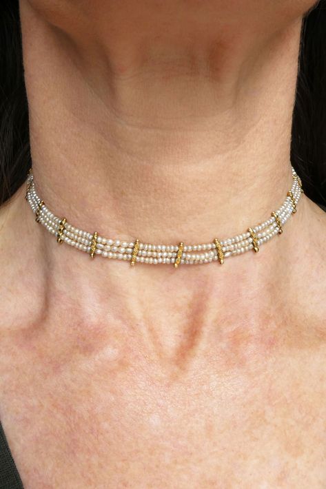 From the Edwardian era, this wonderful pearl and 16ct gold choker necklace consists of countless natural seed pearls hand strung in a three-strand design with eighteen flower embellished dividers, secured by a square box clasp. As well as ornamention, the gold dividers have a lower loop function where gemstone drops likely suspended from at one stage. Today, you may like to leave as is, add your favourite antique lavalier pendant, or bedeck it as it would've been in the Edwardian era! 🤍 The Edwardian Era, Coral Jewelry Set, Contemporary Clothes, Black Beaded Jewelry, Pearl Jewellery, Gold Choker Necklace, Coral Jewelry, Box Clasp, Gold Choker