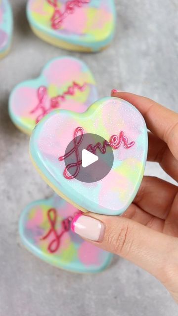 404K views · 9.4K likes | Liz Nicolaou on Instagram: "Lover Era Cookies 💕  100% inspired by the Taylor Swift Album Cover 🥰  No spread cookie dough recipe in my recipe highlights.  Tools used (including the heart mold) in my amazon storefront-linktree in bio  Dabber brushes from @sweet.stamp - use code LOVE10 for 10% off at sweetstamp.online   #heartcookies #chocolatecookies #valentinescookies #valentinesbaking #cookieart #lover #loverera #swiftie #loveisbakeable" Taylor Swift Macarons, Taylor Swift Cookie Cake, Taylor Swift Treats, Taylor Swift Dessert Ideas, Taylor Swift Desserts, Taylor Swift Cookies Decorated, Taylor Swift Sugar Cookies, Taylor Swift Cupcakes, Taylor Swift Cookies