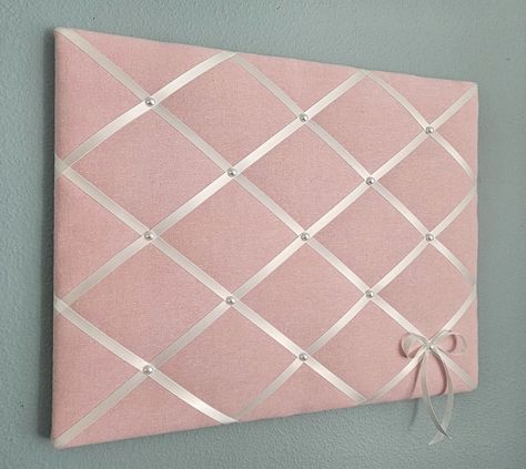 This adorable memo board in soft pink linen mix fabric is accented with off white ribbon and faux pearl details. Use it to display your photos, notes and cards, or just on its own as one of a kind wall hanging. Sizes: 20x16in (pictured) 24x18in 24x20in **Other sizes available, please contact me for details.** My memo boards and fabric pictures are carefully handcrafted using high quality materials, with generous batting. All my boards are light weight, with finished back and come ready to hang. Pink Pin Board, Cute Pinboard, Pink Cork Board, Pin Board Aesthetic, Pin Board Ideas Aesthetic, Pin Board Ideas, Pink Linen Fabric, Decorating Toddler Girls Room, French Memo Boards