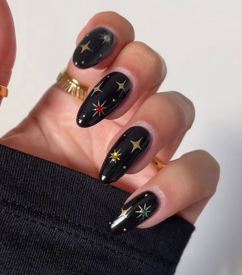 Christmas Witch Nails, Black Gold Star Nails, Moody Acrylic Nails, Engagement Nails Colorful, Dark Nails With Stars, Black Almond Acrylic Nails Design, Celestial Halloween Nails, Witchy Inspired Nails, Green And Black Star Nails