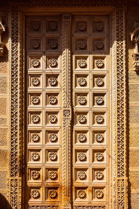 A large wooden door with intricate carvings on it photo – Free India Image on Unsplash Large Wooden Door, Temple Doors, Temple Door, Wallpaper Door, Hd Design, Map Marker, Jain Temple, India Images, Windows Wallpaper