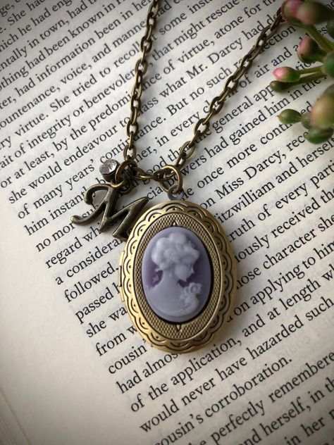 Inspired by the elegant style of early Nineteenth-century England, this beautiful regency-inspired necklace is the perfect accessory for any outfit!  Its antique brass color and decorative cameo locket pendant make it both elegant and fun, allowing it to be worn with casual or formal attire. It is sure to become a favorite piece amongst your jewelry collection! **this item can be personalized with the addition of an antique brass letter charm (see photo)...please just NOTE in the Notes to Seller Purple Locket, Where's Waldo Costume, Regency Accessories, Cameo Locket, Where's Waldo, Dream Future, Inanimate Objects, Necklace Purple, Necklace Initial