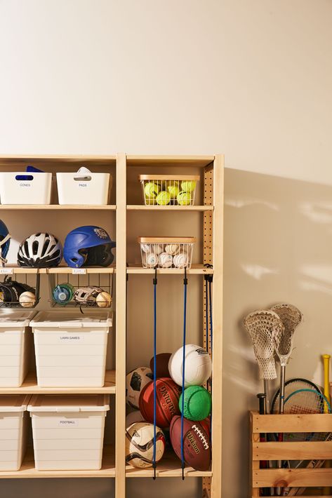 Here's a winning pregame strategy for corralling athletic gear. This system keeps them visible, so your home team can grab, go, and clean up (score!) with ease. #marthastewart #homeimprovement #hometips Ball Corral Diy, Ivar Garage Storage, Ikea Sports Equipment Storage, Ikea Ivar Garage, Ivar Garage, Ball Storage Ideas, Racket Storage, Sports Gear Storage, Sports Equipment Organization