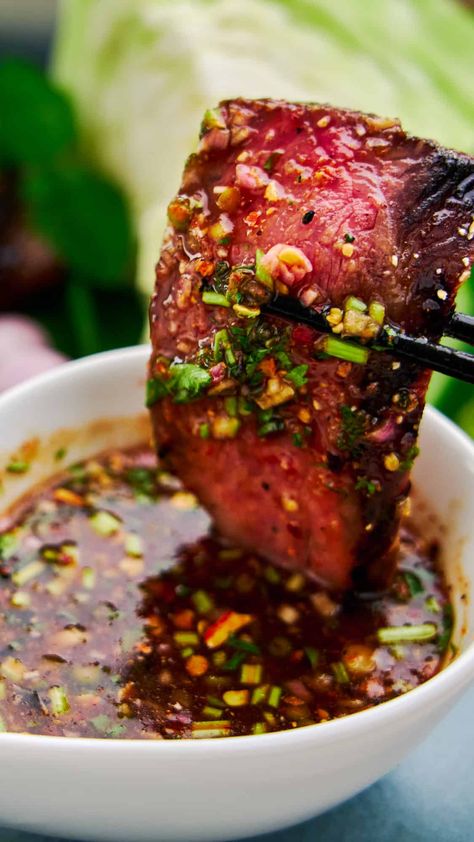 Dipping a medium rare slice of Crying Tiger Beef in spicy Nam Jim Jaew, a spicy tangy and savory Thai BBQ sauce that's addictively good. Crying Tiger Beef, Grilled Beef, Asian Cooking, Beef Dishes, Asian Dishes, Bbq Recipes, Chopsticks, Farmers Market, Good Eats