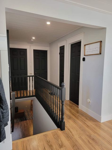 Dark Doors Hallway, Gray Walls And Black Doors, Black Hallways Doors, Dark Doors In Hallway, Black Entryway Door Interior, Black Trim Houses Interior, Black Doors Upstairs, Dark Hallway Doors, Black Doors Gray Walls