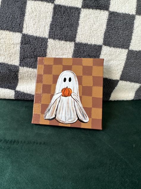 Enjoy this adorable tan and brown checkered background with a ghost holding a pumpkin Ghost Painting!  You get: 4inx4in hand painted ghost with pumpkin and checkered background - original art by me with acrylic paint and so much love, sealed with gloss varnish Easy Paint Ideas On Canvas For Beginners, Mini Fall Canvas Paintings, Cute Fall Ghost Painting, Painting Ghosts On Canvas, Easy Paintings For Halloween, Cute Aesthetic Pumpkin Painting, Ghost Holding Pumpkin Painting, Ghost Painting On Wood, Gouache Pumpkin Painting