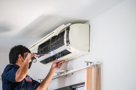 Male technician using a screwdriver fixi... | Premium Photo #Freepik #photo #ac-repair #ac-service #install #maintenance-service Air Conditioning Maintenance, Clean Air Conditioner, Air Conditioner Installation, Ac Repair Services, Refrigerator Repair, Air Conditioning Installation, Ac Service, Air Conditioning Unit, Ac Repair