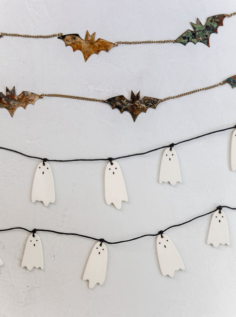 The Ceramic Ghost Garland is the perfect decor piece for your Halloween festivities! This three foot long strand of white ceramic ghosts features face details to give each one a cute, but eerie look. Design Tip: Multiple garlands will likely be needed for your mantel or staircase. Please measure your space and order accordingly. For a fuller look, double up garlands or add in faux stems! *Stock on our Fall Collection is limited.*Halloween items are eligible for returns until October 15th. Halloween Wall Classroom, Halloween Railing Decor, Minimal Halloween Decor, Ceramic Ghosts, Halloween Decor Inspiration, Bat Garland, Glow Projects, Ghost Garland, Cottagecore Halloween