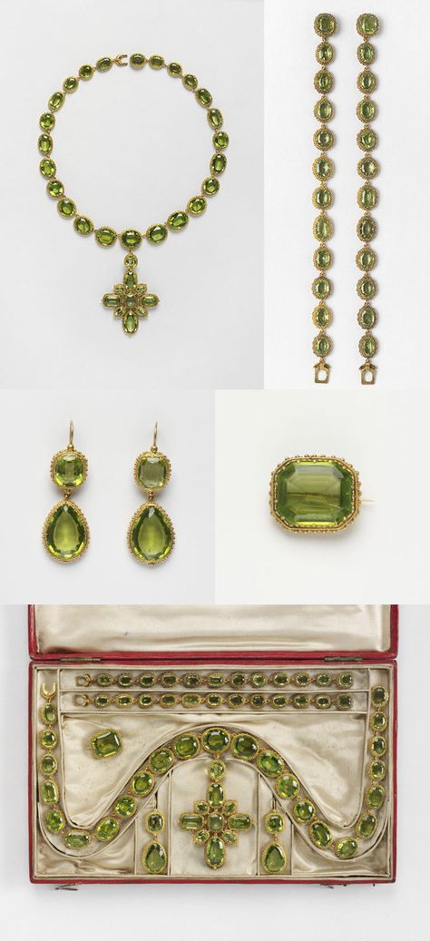 Set of gold and peridot jewels, composed of a necklace with pendent cross, two bracelets, two earrings and brooch. They are contained in a red leather case and have survived with a letter from Princess Elizabeth. Periodot mounted in gold, with gold pin. On 30 April 1816 the Prince Regent, the future George IV, sent to ‘Miss Coats’ a set of peridots to wear at the marriage of his daughter, Princess Charlotte, and Prince Leopold of Saxe-Coburg. Peridot Jewelry Set, Peridot Tiara, Verde Jade, George Iv, Georgian Jewelry, Peridot Jewelry, Historical Jewellery, Princess Elizabeth, Peridot Earrings