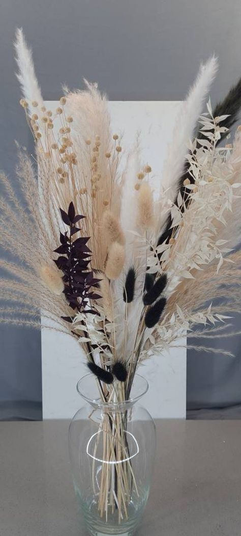 This beautiful white and cream pampass grass, ruscus and black bunnytail bouquet is dried and preserved ready for your home. The bouquet is 52-60cm tall and includes a variation of  -Cream, black and white fluffy pampas grass stems -Black and white ruscus stems  - Natural and black bunnytails. Care instructions included. Please note that the variation of pampas grass might look different due to lighting Gift wrapping option available Black Pampas, Pampas Grass Home Decor, White Ruscus, Dried Flower Bouquets, Grass Bouquet, Cream Decor, Pampas Grass Bouquet, Grass Decor, Pampas Grass Decor