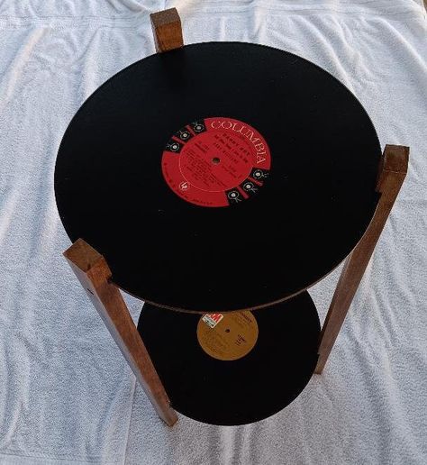 Unique side table constructed using Vinyl records.  Record shelves are supported by a plywood support and structural cross supports. Very strong and designed to provide years of enjoyment. Records are good physical quality with no scratches or obvious flaws. Record shelves are coated with 3 layers of high gloss finish to resist marking. Approximately 24 inches high and 13 inches wide. Ships securely with legs disassembled and includes 6 screws and predrilled locations for quick, sturdy assembly. Gabriela Core, Side Table Plant, Table Beige, Table Minimalist, Record Crafts, Table Retro, Cool Room Decor, Table Decorating, Side Table Decor