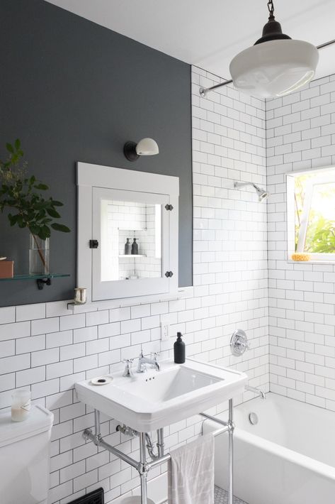 White subway tiles and dark grout give the new bathroom a crisp, clean look. Tagged: Bath Room, Soaking Tub, Wall Mount Sink, Pendant Lighting, Two Piece Toilet, Subway Tile Wall, and Wall Lighting.  Photo 19 of 20 in Before & After: A DIY Couple Tackle Their 1915 Craftsman in San Diego Vintage Bathroom Lighting, Dark Grout, Diy Couple, Craftsman Bathroom, Bathroom Improvements, Subway Tiles Bathroom, Mold In Bathroom, Viborg, White Subway Tiles