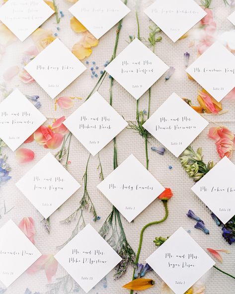 For the seating chart, wedding planner Rebecca Marín Shepherd of The Wildflowers placed pressed wildflowers between a tablecloth and a sheet of plexiglass. The table assignments were attached to the top. #weddingtableassignments #weddingseatchart #weddingreception #weddingtables | Martha Stewart Weddings - A Flower-Filled Spring Wedding in Texas Colourful Seating Chart, Seating Chart With Favors, Floral Seating Chart Wedding, Flower Seating Chart, Diy Seating Chart, Wedding Table Planner, Secret Garden Parties, Kissing Booth, Garden Party Wedding