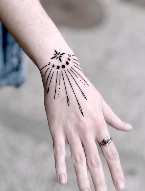 76 Hand Tattoos For Women with Meaning - Our Mindful Life Wrist And Finger Tattoos For Women, Hippy Hand Tattoos For Women, Right Left Tattoo Hand, Wrist Finger Tattoo, Hand Tattoos For Women Design, Woman’s Hand Tattoo Design, Geometric Hand Tattoo Design, Witches Hand Tattoo, Simple Hand Tattoos For Women Unique