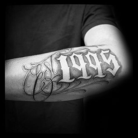 Cool 1995 Negative Space Guys Est Outer Forearm Tattoo 2004 Tattoo Design, Est Tattoos, Est. Tattoo, Traditional Chicano Tattoos, Lettrage Chicano, Art Chicano, Chicanas Tattoo, Outer Forearm Tattoo, Omerta Tattoo