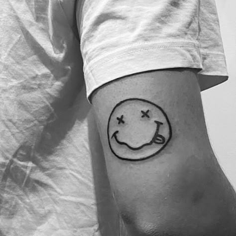 Nirvana Tattoo Smiley, Nirvana Face Tattoo, Small Nirvana Tattoo, Nirvana Smiley Face Tattoo, Kurt Cobain Tattoo Ideas, Nirvana Logo Tattoo, Nirvana Tattoo Lyrics, Grudge Tattoos, Music Tattoos Men