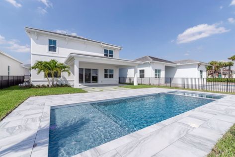 Entertaining and relaxing is a breeze from the lakefront outdoor oasis featuring an expanded covered lanai, luxurious porcelain pool pavers with turf inlays, and a generously sized pool with a sun shelf & flush spa. #floridahomes #interiordesign #realestate #homedesign #homedecor #luxuryhome #designideas #palmbeachcountyhomes #palmbeachcountyrealestate #pooldesign #poolideas #pooldecor #poolside Pavers With Turf, Pool With Sun Shelf, Pool Patio Pavers, Sun Shelf, Covered Lanai, Pool Pavers, Pool Waterfall, Flex Room, Pool Decor