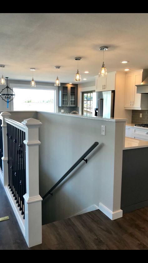 Open Concept With Basement Stairs In Middle, Opening Up Basement Staircase Wall, Open Basement Stairs In Kitchen Half Walls, Basement Open Staircase, Basement Stairs In Middle Of Room, Pony Wall Staircase, Stairs To Basement In Living Room, Stairs In Middle Of House, Open Staircase Ideas Half Walls