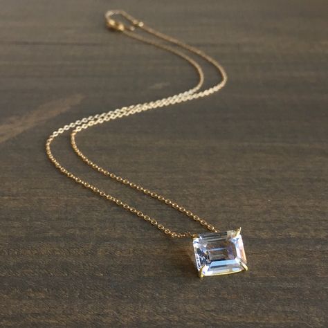 Rosanne Pugliese White Topaz Necklace. Emerald cut white topaz prong set in 18k yellow gold, suspended from a 14k yellow gold chain. This necklace and other similar pieces are available at Meeka Fine Jewelry. #whitetopaznecklace #whitetopaz #18k #14k #rosannepugliese #finejewelry #futureheirlooms #lovegold Emerald Cut Necklace, Emerald Diamond Pendant, White Topaz Necklace, Statement Piece Jewelry, Vintage Jewelry Antique, Necklace Emerald, Pendant Necklace Simple, Bracelet Stone, Gold Topaz