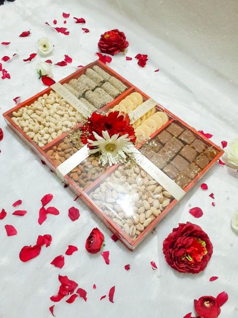 A gift hamper made with rich dry fruits and nuts for engagement, wedding or party events. Link for tray with compartments given below: https://www.amazon.in/MosQuick%C2%AE-Divided-Appetizer-Compartments-Platters/dp/B0C1BY12MS/ref=sr_1_53?crid=2T8XCHVU8T0EW&keywords=tray+with+compartments&qid=1687679616&sprefix=tray+with+compartment%2Caps%2C202&sr=8-53 Nuts Hamper, Dry Fruits Packing Ideas Gift, Dry Fruits Hamper, Engagement Packing Ideas For Bride, Fruits Hamper, Engagement Packing, Dry Fruit Tray, Fruit Hampers, Sweet Hampers