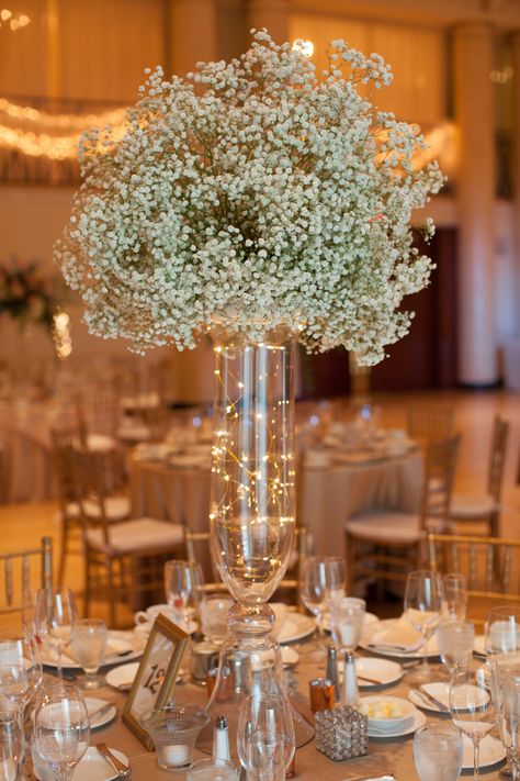 Voluminous baby's breathe and fairy lights add a magical touch for Jesse and James at DuPont Country Club. Amy Tucker Photography. Fairly Light Centerpiece, Fairy Lights Flower Centerpiece, Fairy Light Flower Centerpieces, Center Piece For Prom, Simple Centerpieces Quinceanera, Fairy Lights In Cylinder Vase, Wedding Table Decorations For Round Tables, Wedding Centerpiece With Fairy Lights, Table Decor For Quinceanera