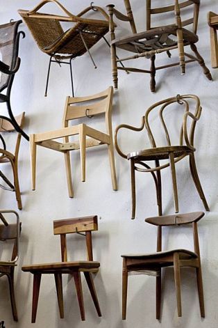 Chairs made by Josh Duthie hang on the wall at Woodshop in San Francisco, Calif., on Monday, December 20, 2010. Photo: Laura Morton, Special To The Chronicle Hanging Chairs On Wall, Chair Wall Ideas, Hang Chairs On Wall, Chair Display Ideas, Chair On Wall, Chairs On Wall, Chair Display, Cowhide Bar Stools, Furniture Store Display