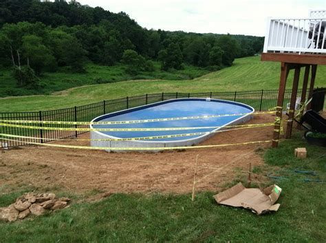 installing above ground pool j hook liner #abovegroundpool Pool On Hill, Radiant Pool, Radiant Pools, Hillside Pool, Hot Tub Landscaping, Swimming Pool Decks, Sloped Yard, Sloped Backyard, Diy Swimming Pool