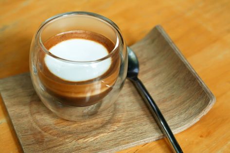 A cup of  espresso macchiato on a wooden table Espresso Machiatto, Cup Of Espresso, Tea Business, Espresso Macchiato, Coffee Business, At The Table, Wooden Table, Wooden Tables, The Table