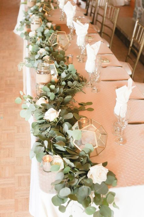 Here's a modern rustic greenery garland we created for Christina & Ryan's wedding head table! We spiced it up with Geometric Gold vases with LED candles inside, and and silver votives. Taken by EMBLAZEPhotography at the Waterstone Estate & Farms :) Cheap Wedding Table Centerpieces, Head Table Wedding Decorations, Wedding Head Table, Greenery Wedding Centerpieces, Wedding Candles Table, Head Table Decor, Head Table Wedding, Tafel Decor, Bridal Table