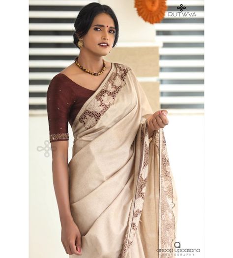 #Repost
///@rutwva_insta: M.A.P.L.E 🍁
.
Simple beige brown saree with cutwork detail on borders.

These cutworked borders are highlighted with handembroidery in cutbeads and beads.

This look is completed by pairing it with a burnt coffee pure rawsilk blouse with handembroidered sleeves.
.
Drop a message or contact on 9207675346/8848874044 for orders and enquiries.

Muse : @gourry_bhadhraas 
Photography : @anoopupaasana_photography 
MUA : @parinayah @rabisruthy 
Outfit&styling : @rutwva_insta Cream Colour Saree Blouse Combination, Coffee Brown Blouse Designs, Beige Saree With Contrast Blouse, Brown Saree With Contrast Blouse, Brown Saree Combination Blouse, Brown Blouse Designs For Saree, Coffee Brown Saree Combination Blouse, Coffee Brown Saree, Blouse Designing