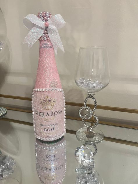 Beautiful hand decorated bottle with sparkling iridescent pink glitter.  Pearl gem border. Stunning pearl detail on the neck. This bottle is sold empty and the gemstone cap is sealed shut. This glam bottle is the perfect addition to your room, a gift, or table centerpiece for your special occasion. Please contact me if a larger quantity is needed, or with any other questions.  Perfect to use for:  - home decor - bar/restaurant decor - birthday parties - weddings - special occasions Decorated Champagne Bottles Quinceanera, Pink Glam Party Ideas, Wine Bottle Crafts Birthday, Pink Glitter Bottle, Paper Mache Wine Bottles, Badazzel Bottle, Fancy Wine Bottles, Don Julio Bottle Decorated Pink, Bottle Centerpieces Birthday