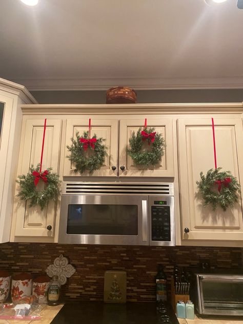 Top Of Cabinet Decorating Christmas, Christmas Above Cabinets Decor Kitchen, Above The Cabinets Christmas Decor, Kitchen Cabinet Top Decorating Ideas For Christmas, Christmas Bows Kitchen Cabinets, Christmas Decor Small Kitchen, Christmas Decorations For Cabinets, Wreaths Kitchen Cabinets, Holiday Cabinet Decorations