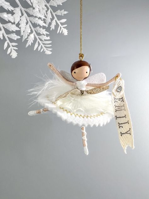 This delicate ballerina flower fairy ornament is perfect for those who appreciate unique and personalized gifts. With wisps of feathers at her waist, golden embroidery on her felt skirt, and glittery wings on her back, this snow princess is ready for her performance. Size: 3.75" - Hand-painted facial details on wood, select your hair and skin color  - Made with quality embroidery floss  - Holographic Star on her hair - Metallic cord for hanging  - All items are uniquely crafted and may vary slightly in size and appearance - Each order is packaged in a drawstring bag - Gift messaging can be included, enter the details at checkout -- OPTIONAL PERSONALIZATION: Add a hand-stamped name tag to personalize your fairy. You can also use mom, grandma, or a year.  In the personalization box, enter th Fairy Diy Crafts, Felt Skirt, Swan Lake Ballerina, Ballerina Flower, Ballerina Ornaments, Snow Princess, Felt Fairy, Fairy Crafts, Gold Embroidery