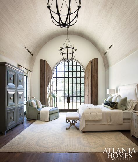 The 18-foot barrel-vault ceiling in the master bedroom is more dimensional thanks to antique-finished wooden boards. Judy Long, a decorator friend of Lisa and Michael, devised the solution for arched door shutters for privacy and to protect from harsh lighting. Shutters Repurposed Decor, Barrel Vault Ceiling, Black Curves, Atlanta Homes, Tuscan Style, White Box, Living Room Paint, Beautiful Bedrooms, My New Room