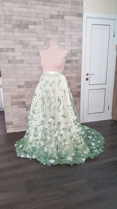 Flower embroidered light green tulle detachable wedding skirt with train - an elegant adding to your wedding gown can be matched with different styles wedding gowns and tops. Also, the skirt can be ordered in full, with Royal satin underneath skirt, Tulle crinoline and Lining. Please select all your preferred options and indicate your size at checkout. Kindly note that this listing is for the skirt presented in the first pictures. In case you are interested to buy one of optional items from the Green And White Gown, Floral Wedding Skirt, Dino Wedding, Detachable Wedding Skirt, Wedding Overskirt, Bridal Skirt Separate, White Flower Wedding, Wedding Train, Train Skirt