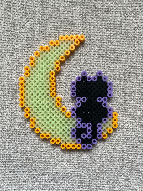 Cat sitting on moon perler bead magnet made with glow in the dark, amber, black, and lavender beads. Perler Bead Patterns Star Board, Perler Bead Goth, Perler Bead Patterns Cat, Perler Bead Gift Ideas, Halloween Melty Beads, Glow In The Dark Perler Bead Patterns, Perler Bead Bat, Ironing Beads Pattern, Moon Perler Bead Pattern