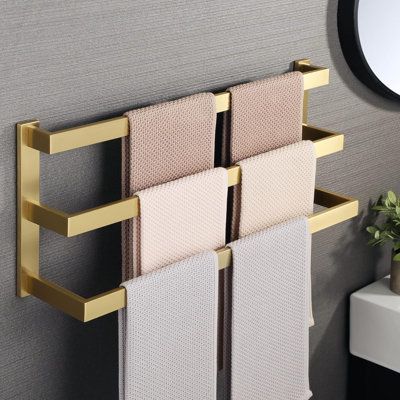 Elevate your bathroom experience with this sleek and modern towel rack. Its space-saving design is perfect for compact bathrooms, while its sturdy construction ensures long-lasting durability . Made in the USA. Finish: Gold | KD Wall Mounted Towel Rack 10.64 H x 23.04 W x 5.12 D in yellowMetal in Gold | 23.04" L;23.04" L;23.04" L | Wayfair G0B51KR8JN Gold Towel Rack Bathroom, Towel Bars In Bathroom Ideas, Towel Bars In Bathroom, Bathroom Towel Hanging Ideas, Gold Towel Rack, Towel Hanging Ideas, Modern Towel Rack, Bathroom Hand Towel Holder, Mounted Towel Rack