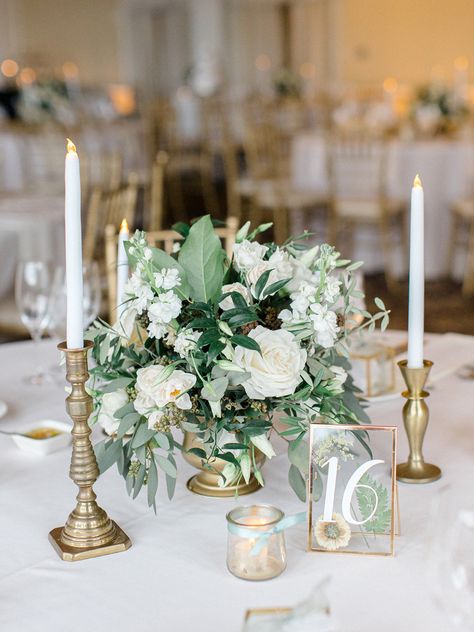 Candlesticks And Flowers Wedding, Wedding Table Decor Sage Green, Green Floral Centerpieces Wedding, Gold Candle Stick Wedding Centerpieces, Sage Wedding Round Table Decor, Sage And White Wedding Centerpieces, Green Gold White Centerpieces, Candlestick Table Number, Sage Green Wedding Table Centerpieces