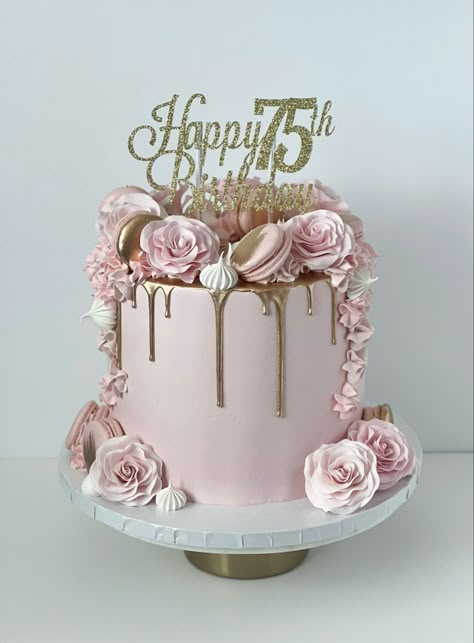 Pink cake with a gold drip. On top and down the sides are sugar roses, macarons, and meringues. On top there is a gold and sparkly cake topper that reads “Happy 75th Birthday” 75th Cake Ideas, Cake Ideas For 75th Birthday, Cakes For 75th Birthday Mom, Birthday Cake For 75 Woman, 75th Cake Topper, Cake 75th Birthday For Women, Pink 70th Birthday Cake, 75th Bday Cake For Mom, 75 Th Birthday Cake Designs