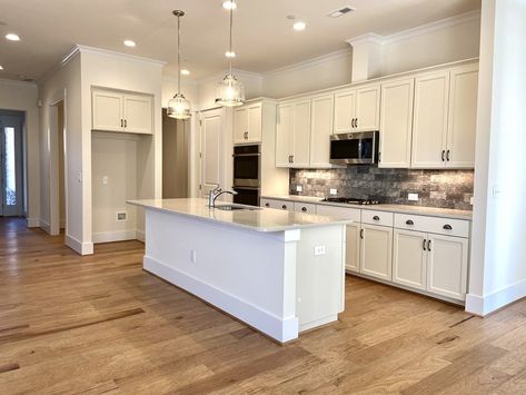 How to Create a Warm White Kitchen - Niblock Homes Kitchen Flooring Ideas With Maple Cabinets, Kitchen Floor White Cabinets, White Kitchen Light Wood Floors, How To Warm Up A White Kitchen, Kitchen Ideas Classic, Warm White Kitchen, Ivory Kitchen Cabinets, Taupe Flooring, Taupe Kitchen Cabinets