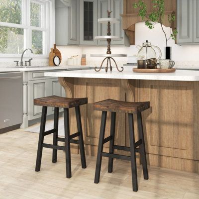 Combining solid wood material and simple appearance as one, these stools can add a natural feeling to any room space. Whether it's at home, in a restaurant, cafe, pub, or any other setting, these stools are the perfect companion. Seat Height: Bar Stool (29" Seat Height) | 17 Stories Solid Wood Saddle-Seat w / Curved Seat Surface & Comfortable Footrests black / Wood in Brown | Bar Stool (29" Seat Height) | Wayfair Farmhouse Kitchen Stools, Black Bar Stools Kitchen, Country Bar Stools, Saddle Seat Bar Stool, Farmhouse Bar Stools, Rustic Bar Stools, Sitting Space, Black Counter Stools, Brown Bar Stools