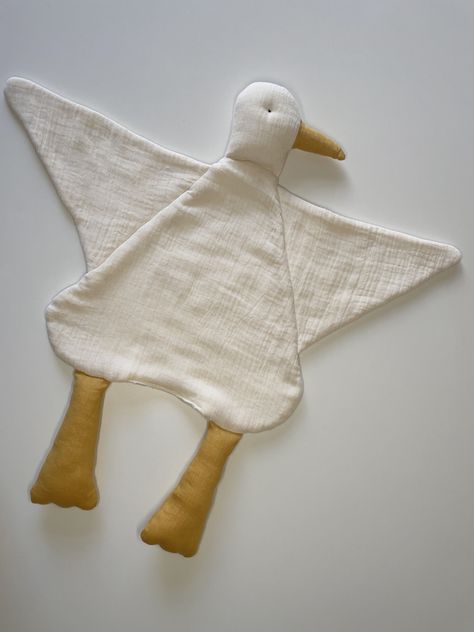 Soothe little ones to sleep with the cozy goose comforter blanket that was made to be loved and held. Made with 3-layers of super-soft breathable muslin cotton and 100% natural batting. Ideal for baby to cuddling while sleeping and baby shower gift.  * Composition: -outer layer:  100% organic unbleached undyed muslin cotton;  - inner layer: 100% natural batting; - beak and legs 100% flax linen filled with 100% hyperallergenic polyfill stuffing fiber.  * Size:  L 22"x W 24"  * Available in colors Diy Lovey For Baby, Baby Muslin Blanket, Baby Blanket Sewing, Goose Baby Shower Ideas, Baby Items To Sew, Sewing Projects For Baby, How To Sew Baby Blanket, Homemade Baby Gifts, Diy Baby Blanket