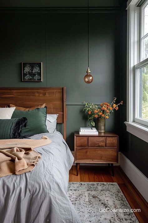 We’re moving on to darker greens for a more moody aesthetic. The wooden features here are a bit more pronounced to pop out from the deeper colors. Dark Green Bedroom Walls Paint, Moody Main Bedroom, Simple Bedroom Aesthetic Ideas, Color Drenching Green Bedroom, Bedroom Inspirations Master Moody, Dark Green Carpet Bedroom, Dark Moody Mid Century Modern Bedroom, Moody Green Bedroom Ideas, Moody Scandinavian Bedroom